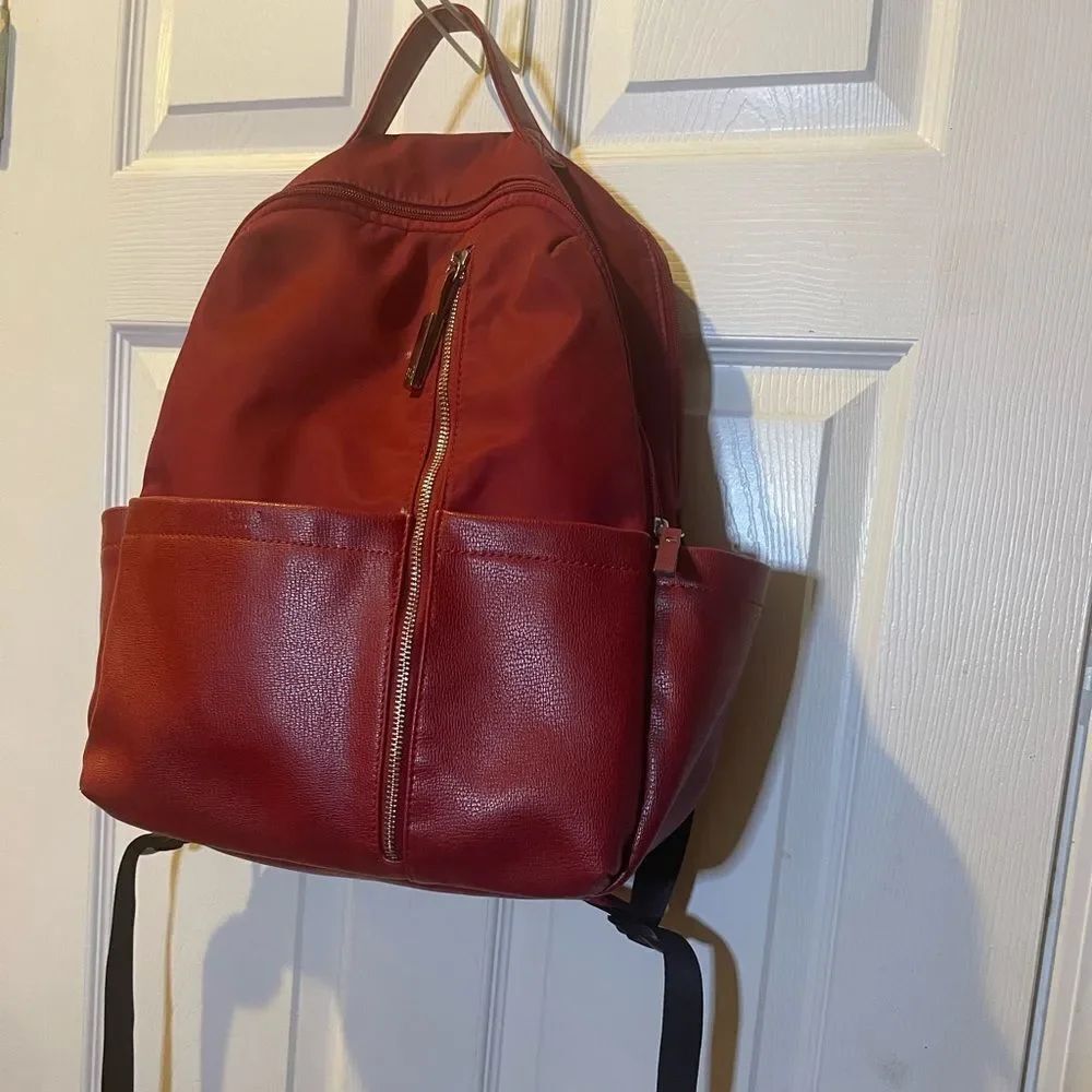 Tutilo Synthetic leather & Nylon Red padded Backpack gold tone hardwares .